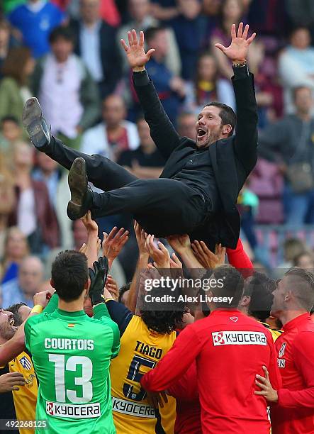 Diego Simeone the coach of Club Atletico de Madrid is thrown in the air by his players after winning the La Liga after the match between FC Barcelona...