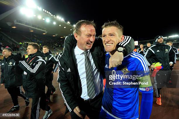Northern Ireland Manager Michael O'Neill and Captain Steven Davis celebrate after the UEFA EURO 2016 Qualifying match between Finland and Northern...