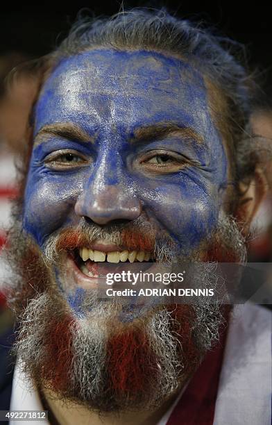 Rugby fan with his face poses in the crowd ahead of the Pool B match of the 2015 Rugby World Cup between USA and Japan at Kingsholm stadium in...