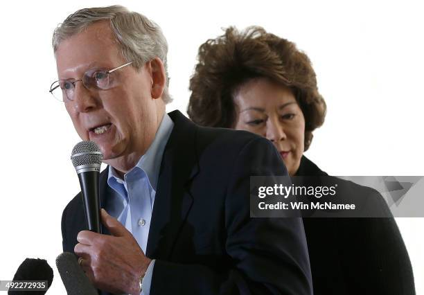 Senate Republican Leader Sen. Mitch McConnell speaks to supporters while campaigning at an early morning rally with his wife Elaine Chao May 19, 2014...