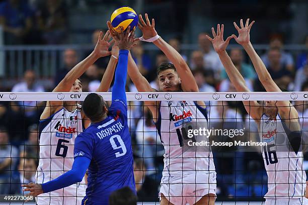 Earvin Ngapeth of France spikes the ball against Simone Giannelli, Matteo Piano and Oleg Antonov of Italy during CEV Volleyball European Championship...