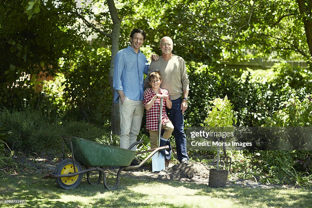 Happy three generation family gardening in park