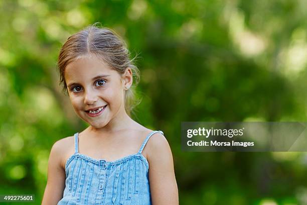 cute girl smiling at park - portrait of a young girl with gappy teeth and blond hair stock pictures, royalty-free photos & images
