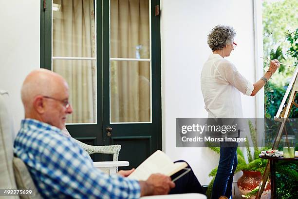 senior couple spending leisure time at porch - standing table outside stock pictures, royalty-free photos & images