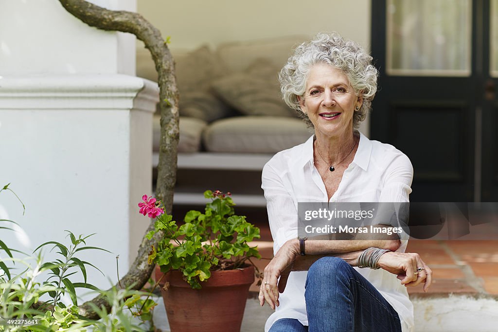 Confident senior woman sitting at porch