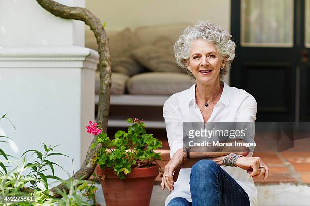 confident senior woman sitting at porch - 70 79 år bildbanksfoton och bilder