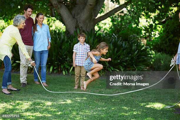 family playing with jumping rope in park - jump rope bildbanksfoton och bilder