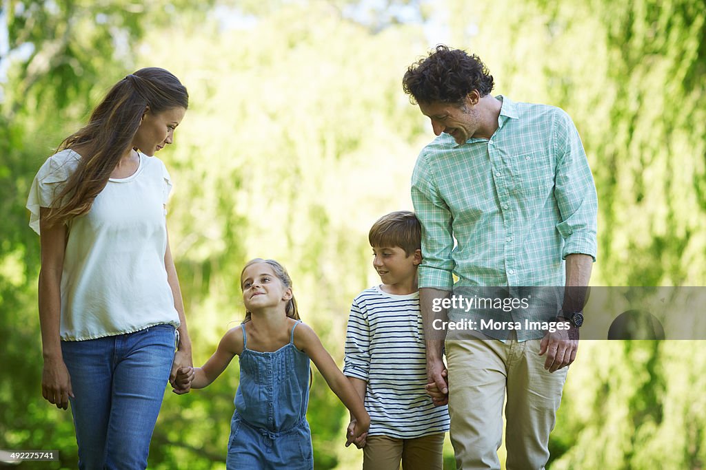 Happy family walking together in park
