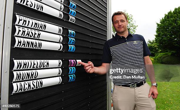 Russ Whitelock of St. Mellion Golf & Country Club poses next to the scoreboard after winning the Powerade PGA Assistants' Championship Western...