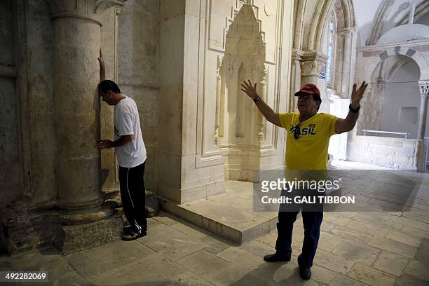 Christian pilgrims from Brazil pray at the Cenacle, or Upper Room on Mount Zion just outside the Old City on May 19, 2014. For Christians, it is the...