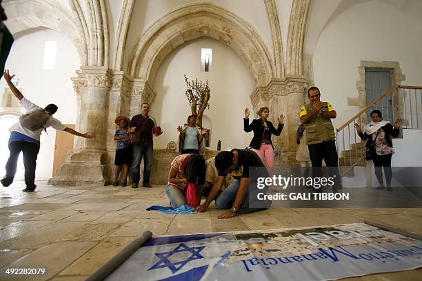 Christian pilgrims from Brazil pray at the Cenacle, or Upper Room on Mount Zion just outside the Old City on May 19, 2014. For Christians, it is the...