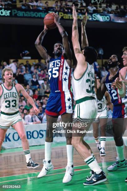 Albert King of the New Jersey Nets shoots against Kevin McHale of the Boston Celtics during a game circa 1986 at the Boston Garden in Boston,...