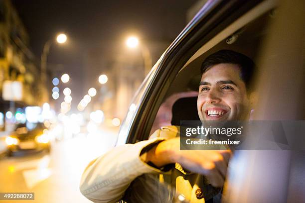 businessman in a car at night - taxi stock pictures, royalty-free photos & images