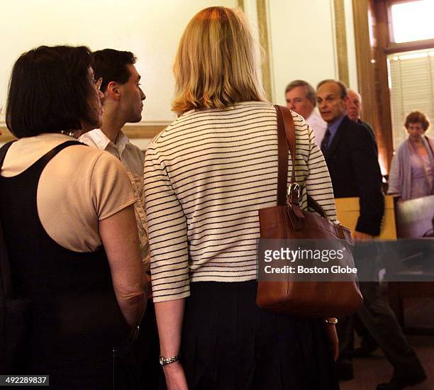 Dr. Dirk Greineder walks past his son, Colin, second from left, and daughter, Britt, center, standing with a family friend, left, as he leaves the...