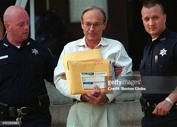 Officers lead Dr. Dirk Greineder, center, out of Norfolk Superior Court in Dedham, Mass. On Thursday evening, June 28, 2001. Greineder, an allergist...