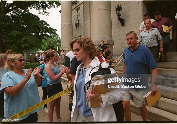 Bystanders applaud as members of the jury leave Norfolk Superior Court in Dedham, Mass. On June 29 after convicting Dr. Dirk Greineder of...