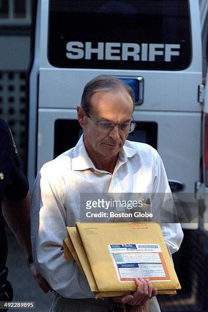 Dr. Dirk K. Greineder is escorted into Norfolk Superior Court in Dedham, Mass. On the morning of June 29, 2001. Greineder, an allergist at Brigham...