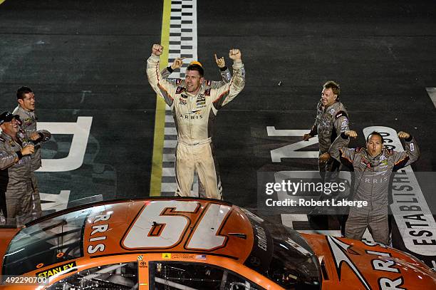 Carl Edwards, driver of the ARRIS Toyota, celebrates with a burnout after winning during the NASCAR Sprint Cup Series Bojangles' Southern 500 at...