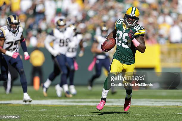 James Jones of the Green Bay Packers runs the football in for a touchdown against the St. Louis Rams in the third quarter on a 65 yard pass from...