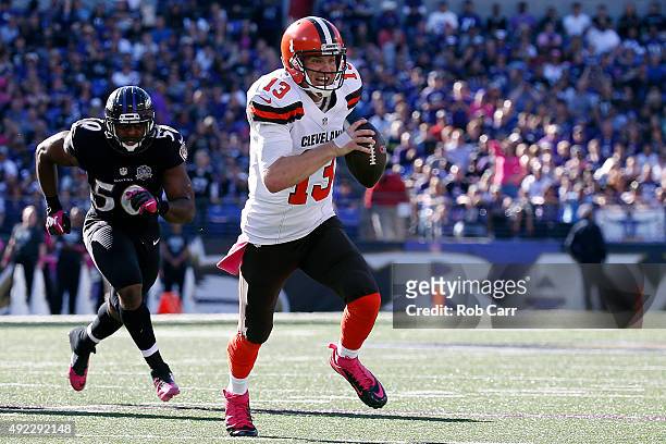 Quarterback Josh McCown of the Cleveland Browns scores a third quarter touchdown past outside linebacker Albert McClellan of the Baltimore Ravens...