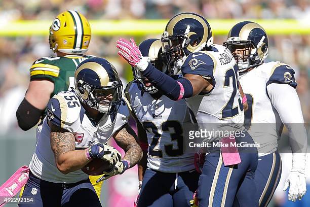 James Laurinaitis of the St. Louis Rams celebrates after intercepting the football against the Green Bay Packers in the first quarter at Lambeau...