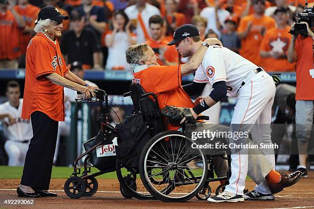 Former President George H.W. Bush greets Jed Lowrie of the Houston Astros prior to game three of the American League Division Series between the...