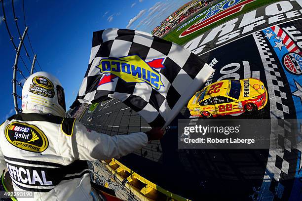 Joey Logano, driver of the Shell Pennzoil Ford, races to the checkered flag to win the NASCAR Sprint Cup Series Bank of America 500 at Charlotte...