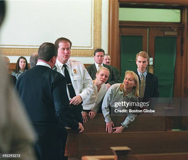 Dr. Dirk Greineder of Wellesley, accused of murdering his wife, is led past his children, Britt, Kirsten, and Colin, during arraignment at Norfolk...