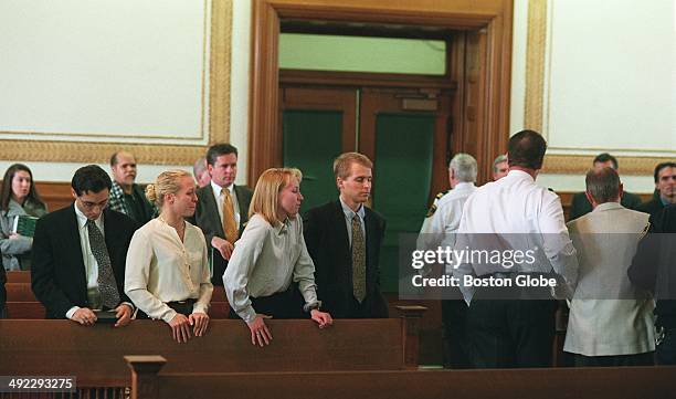 Dr. Dirk Greineder of Wellesley, accused of murdering his wife, is led past his children, Britt, Kirsten, and Colin, during arraignment at Norfolk...