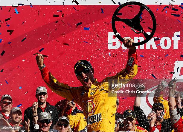 Joey Logano, driver of the Shell Pennzoil Ford, celebrates in Victory Lane after winning the NASCAR Sprint Cup Series Bank of America 500 at...