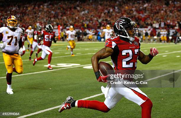 Robert Alford of the Atlanta Falcons returns an interception for a touchdown in their 25-19 overtime win against the Washington Redskins at Georgia...