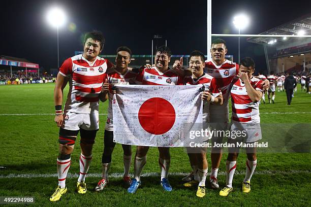 Japanese players pose after the 2015 Rugby World Cup Pool B match between USA and Japan at Kingsholm Stadium on October 11, 2015 in Gloucester,...