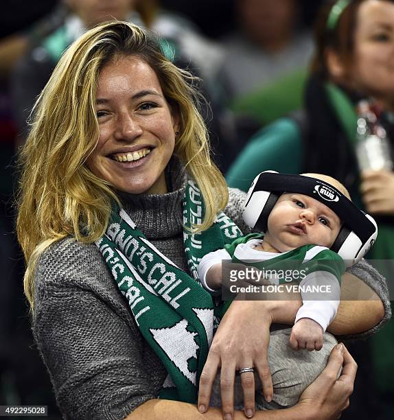An Irish supporter poses with her newborn baby during the Pool D match of the 2015 Rugby World Cup between France and Ireland at the Millennium...