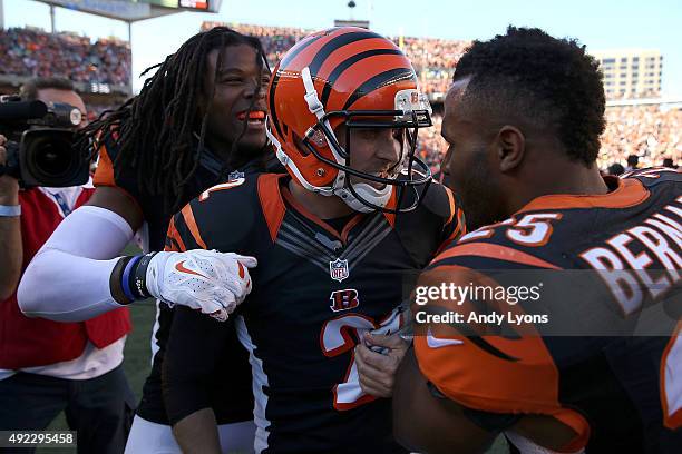 Emmanuel Lamur and Giovani Bernard both congratulate Mike Nugent, all of the Cincinnati Bengals, after he kicked the game winning field goal in...