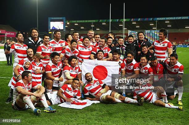 Japan pose for a team photogrpah after the 2015 Rugby World Cup Pool B match between USA and Japan at Kingsholm Stadium on October 11, 2015 in...