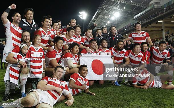 The Japan team pose on the pitch at the end of the Pool B match of the 2015 Rugby World Cup between USA and Japan at Kingsholm stadium in Gloucester,...