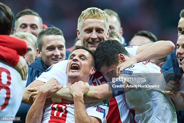 Robert Lewandowski and Slawomir Peszko and Kamil Glik all from Poland celebrate after the UEFA EURO 2016 qualifying match between Poland and Republic...