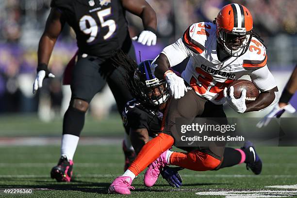 Running back Isaiah Crowell of the Cleveland Browns scores a fourth quarter touchdown past free safety Kendrick Lewis of the Baltimore Ravens during...