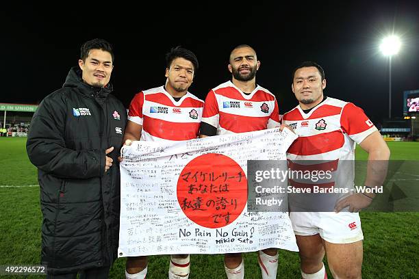 Michael Leitch of Japan and team mates pose for a photo after the 2015 Rugby World Cup Pool B match between USA and Japan at Kingsholm Stadium on...