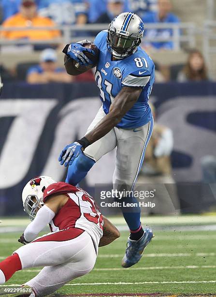 Calvin Johnson of the Detroit Lions runs the ball on a reception that broke the franchise record for career catches during a game against the Arizona...