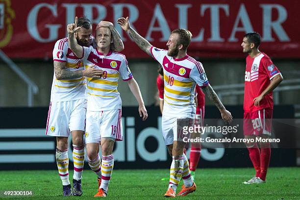 Steven Naismith celebrates scoring their sixth goal with teammates Steven Fletcher and Johnny Russell during the UEFA EURO 2016 Qualifying round...