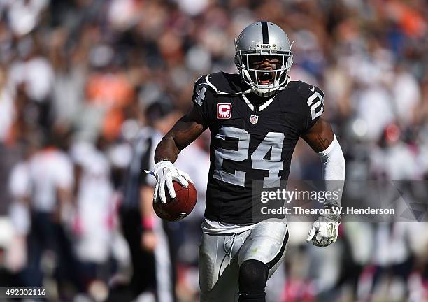 Charles Woodson of the Oakland Raiders celebrates an interception against the Denver Broncos in the third quarter at O.co Coliseum on October 11,...