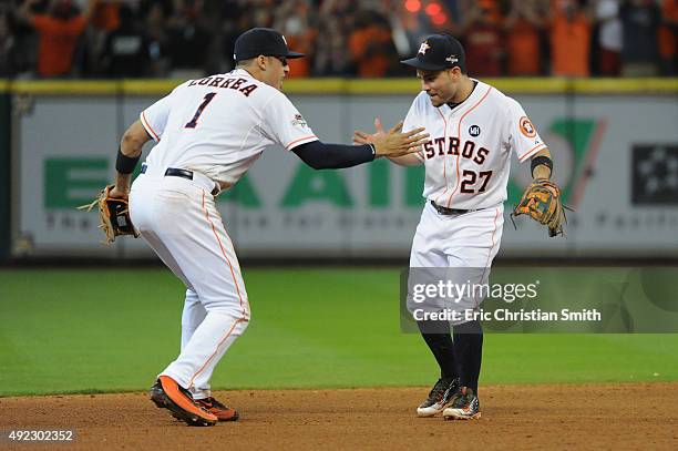 Carlos Correa of the Houston Astros celebrates with Jose Altuve of the Houston Astros after the Houston Astros defeat the Kansas City Royals in game...