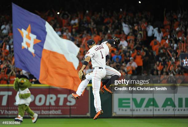 Carlos Correa of the Houston Astros celebrates with George Springer of the Houston Astros after the Houston Astros defeat the Kansas City Royals in...