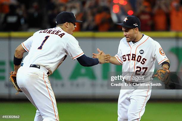 Carlos Correa of the Houston Astros celebrates with Jose Altuve of the Houston Astros after the Houston Astros defeat the Kansas City Royals in game...