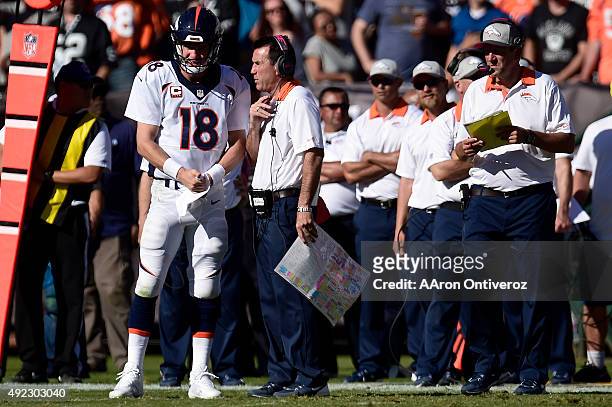 Peyton Manning of the Denver Broncos speaks with head coach Gary Kubiak during the second half of the Broncos' 16-10 win at the O.co Coliseum. The...
