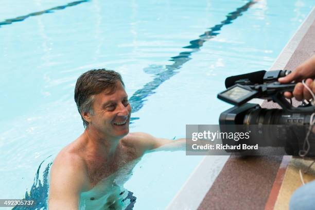 Chairman and CEO of Accor Sebastien Bazin speaks to the guests and medias after a swim in the winter pool at the Piscine Molitor during its...