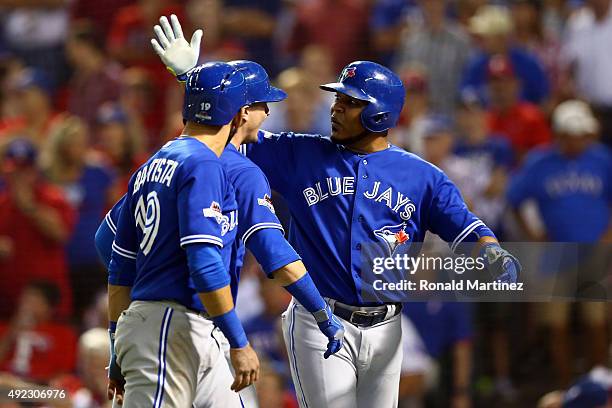 Troy Tulowitzki of the Toronto Blue Jays celebrates with Edwin Encarnacion and Jose Bautista after hitting a three run home run against Chi Chi...