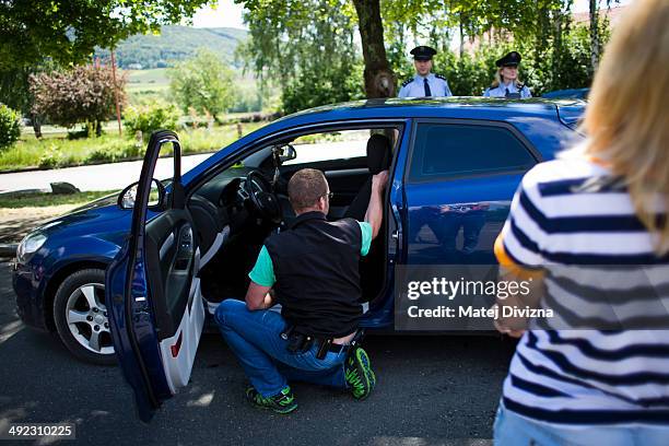 An officer of Bavaria police, with the attendance of officers of Czech police, checks a car while patrolling for crystal meth and other contraband...