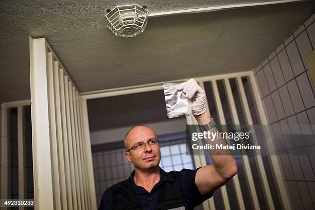 Vilem Kurta, investigator of Bavaria police, shows confiscated crystal meth in the police station on May 19, 2014 in Furth im Wald, Germany. Furth im...